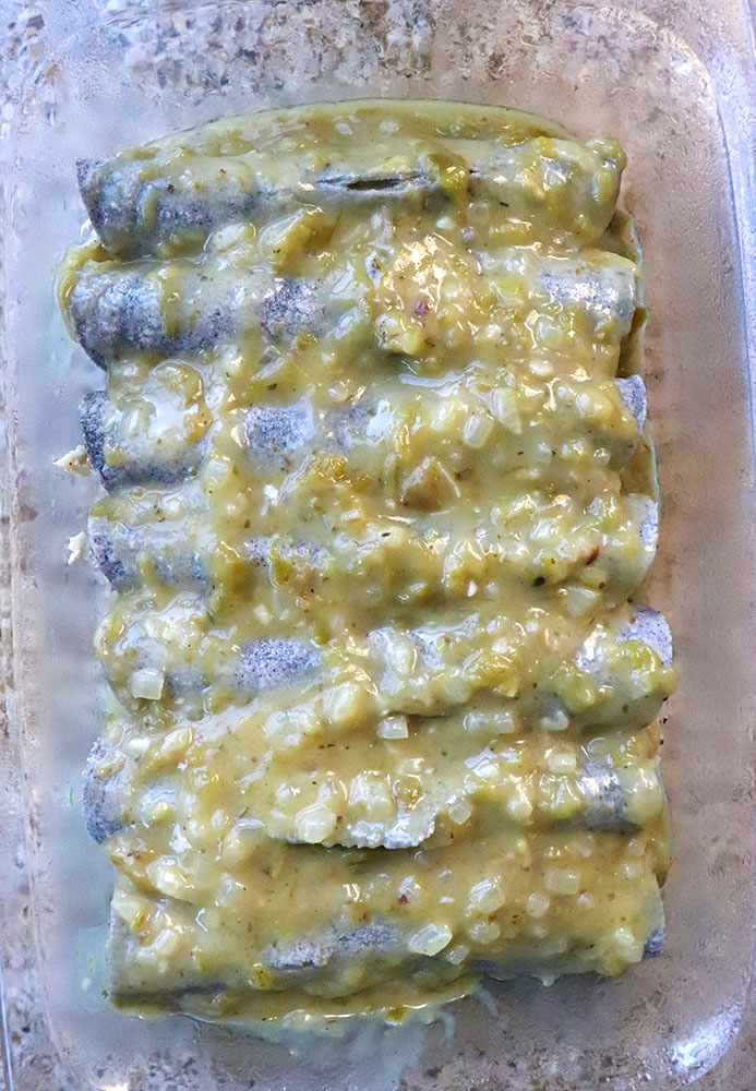 blue corn enchiladas topped with green chile sauce 