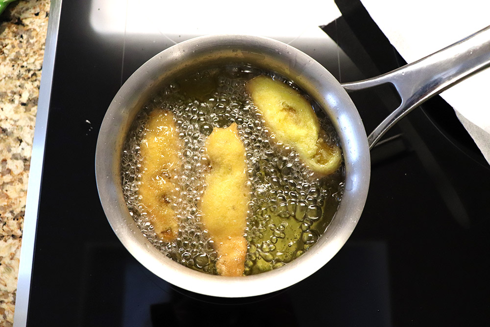 frying chile rellenos