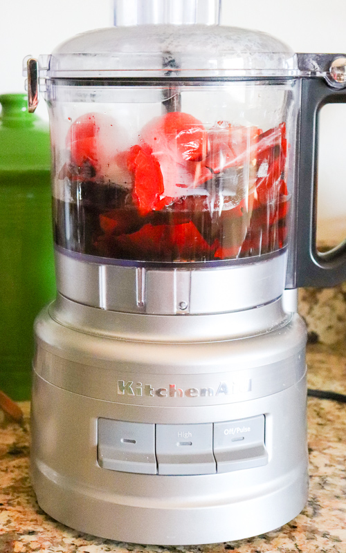 Blender with ingredients for salsa roja